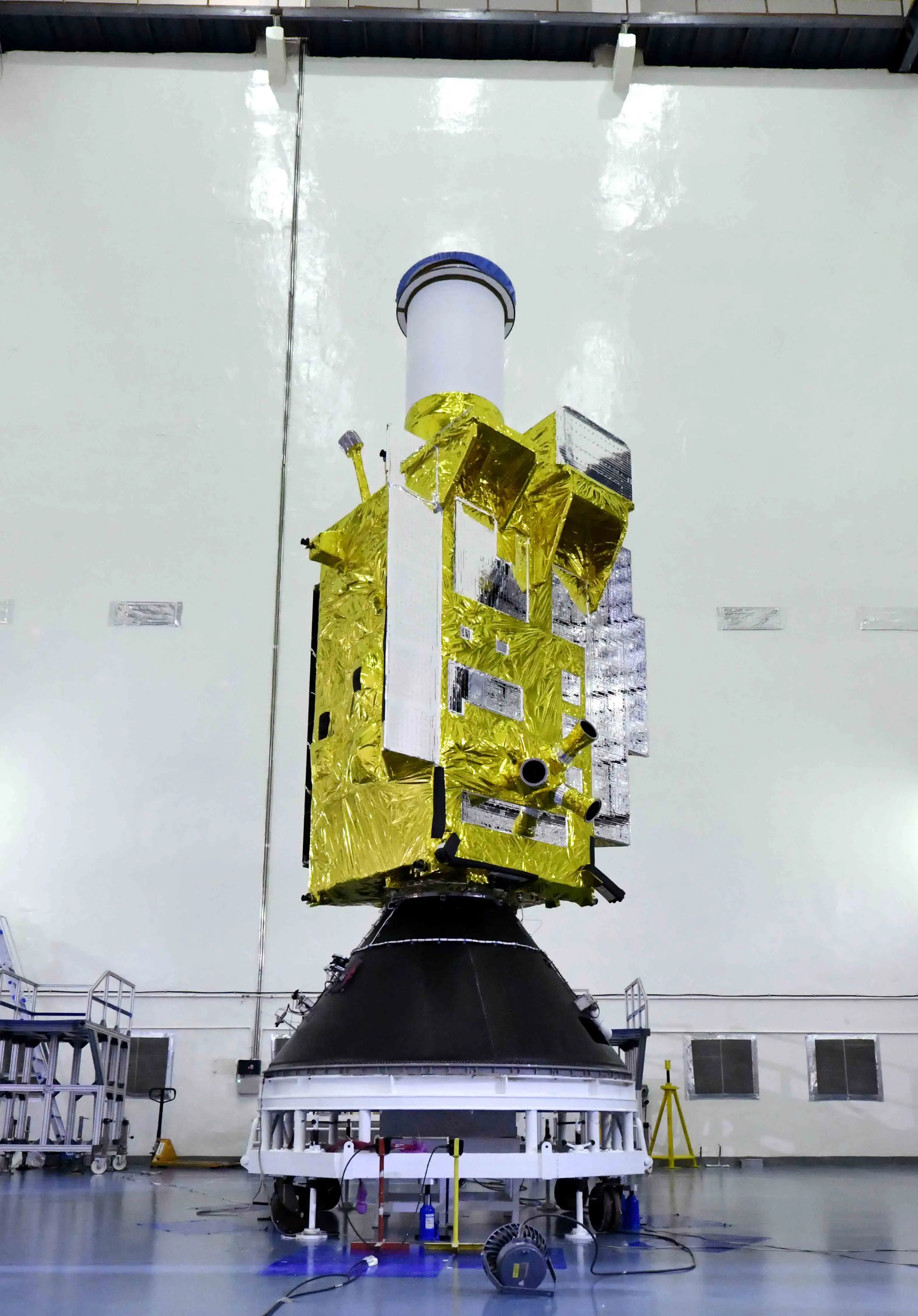 EOS-05 spacecraft, wrapped in gold thermal insulation, mounted vertically during launch preparation